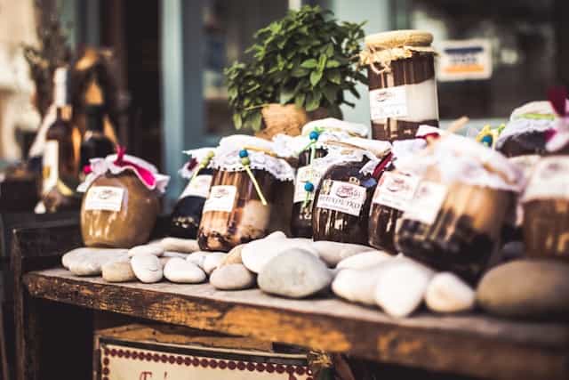 A table with a variety of jams and marmalades displayed in a market in Nafplion