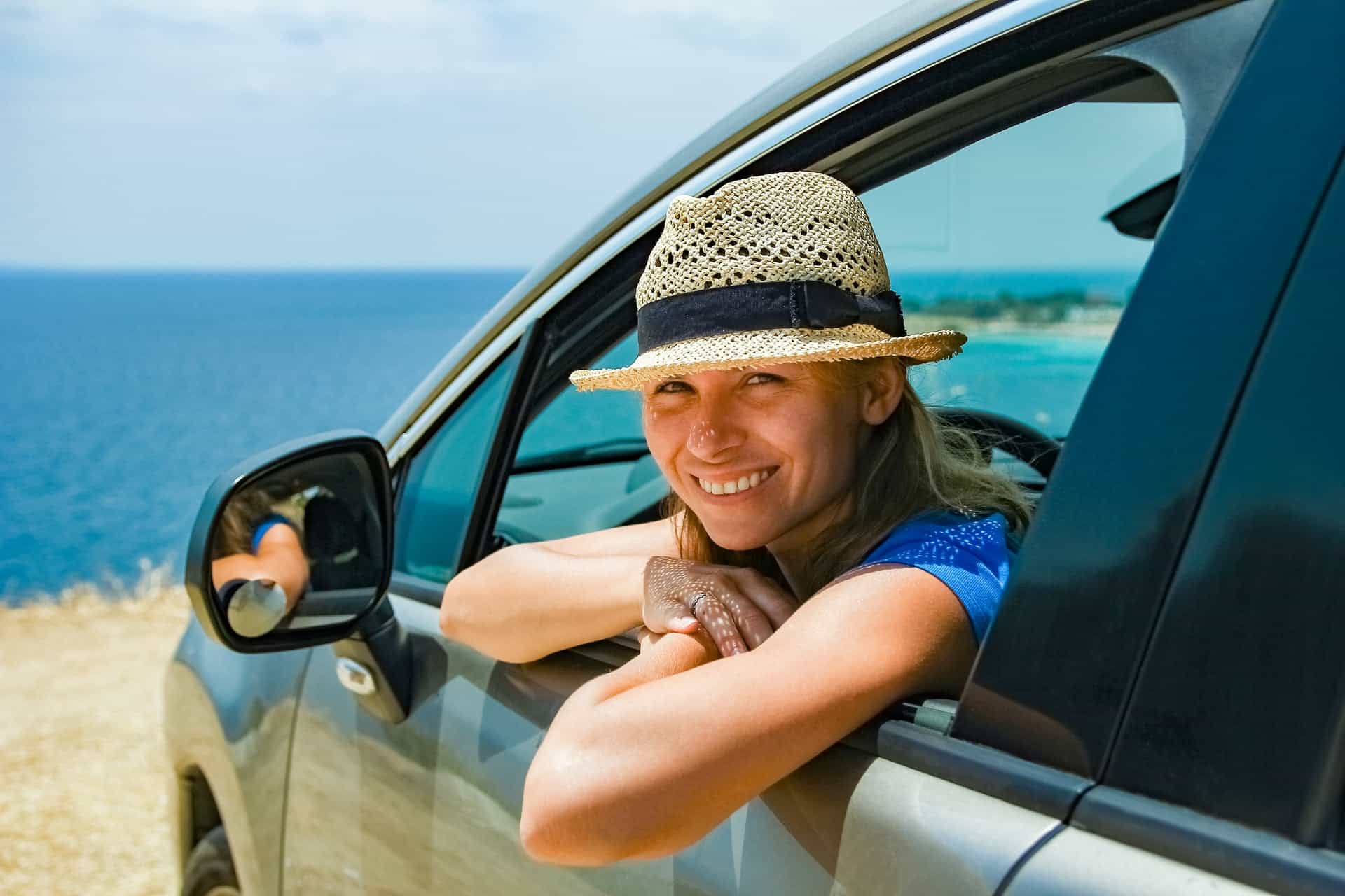 A rental car parked on a scenic coastal road in Greece