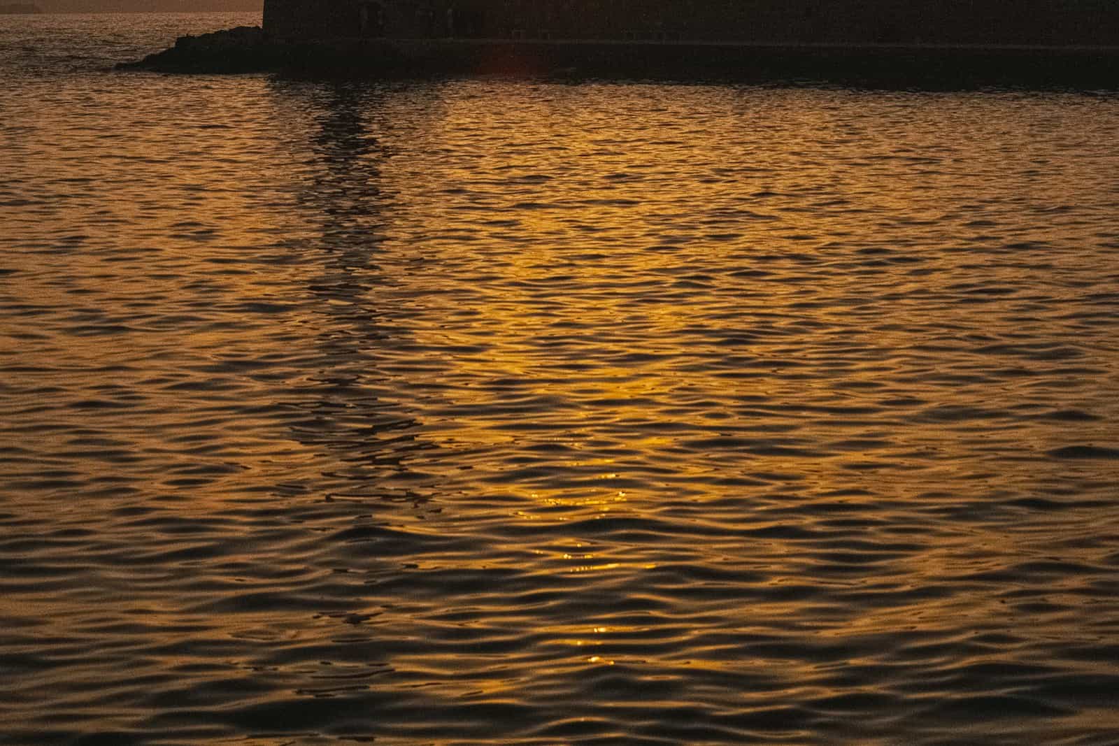 The Venetian harbour lighthouse of Chania at sunset