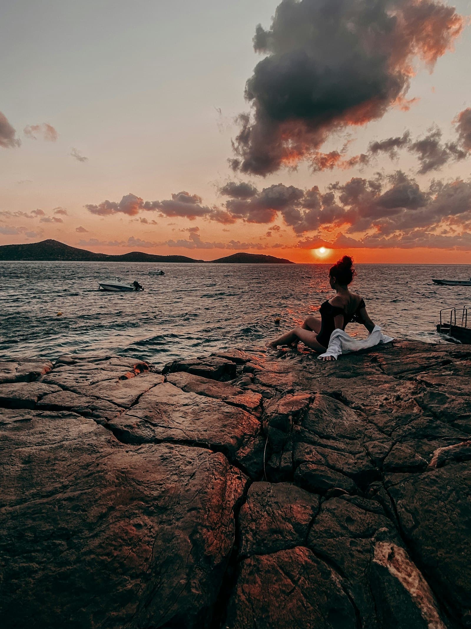 Elounda car rental — a traveller looking out over the sea at Elounda, Crete, Greece