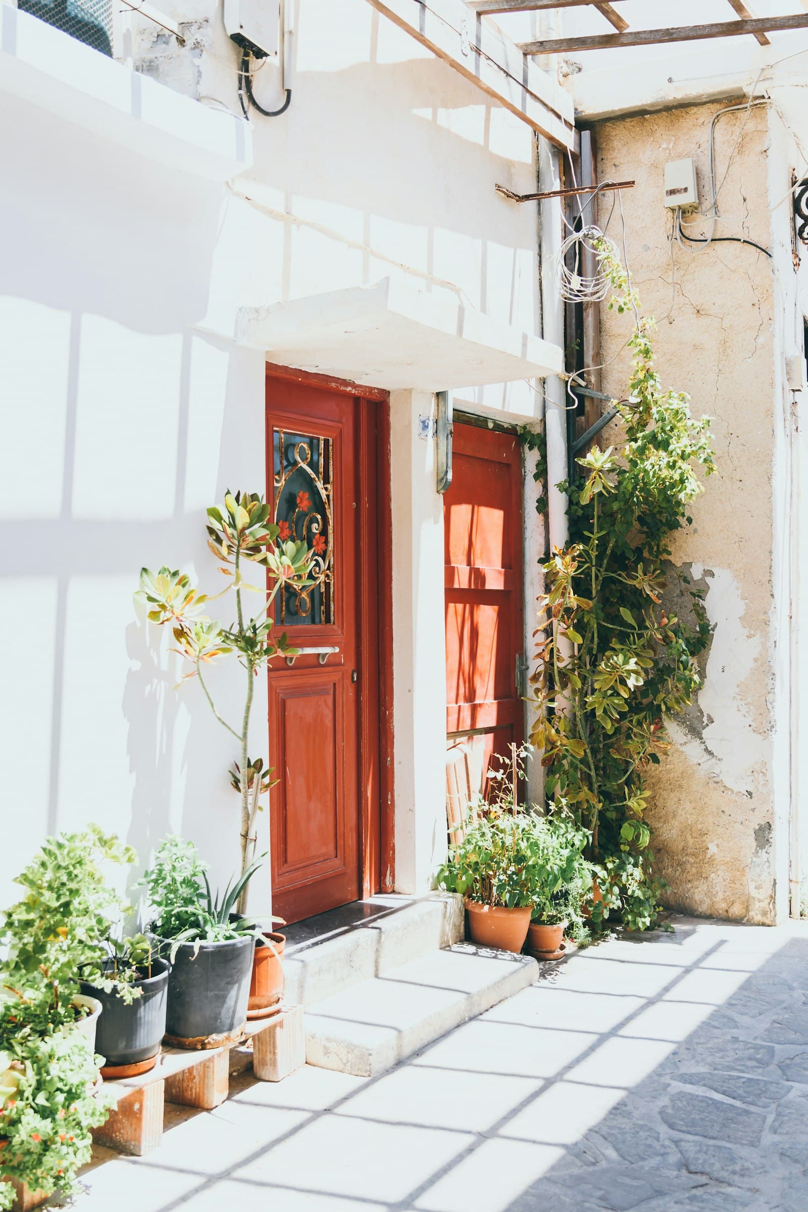 Ierapetra car rental — a traditional wooden door and greenery in the old town of Ierapetra, Crete, Greece