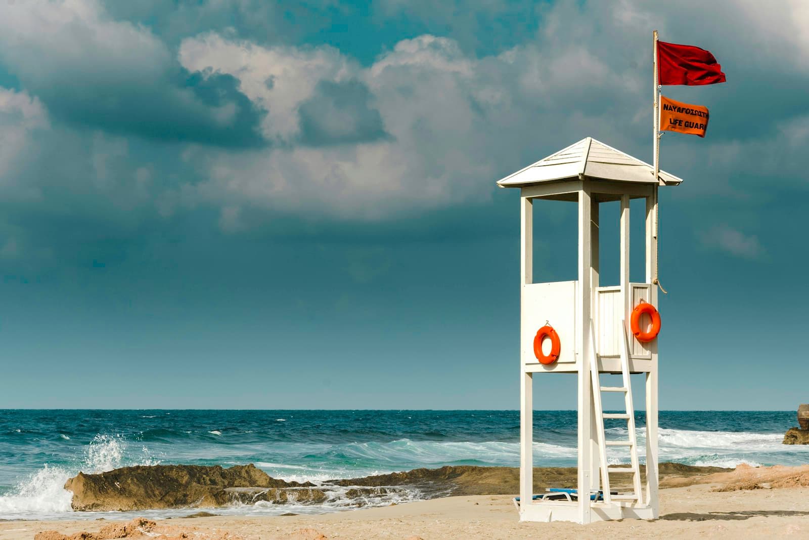 Malia car rental — a white lifeguard hut on the sandy beach at Malia, Crete, Greece