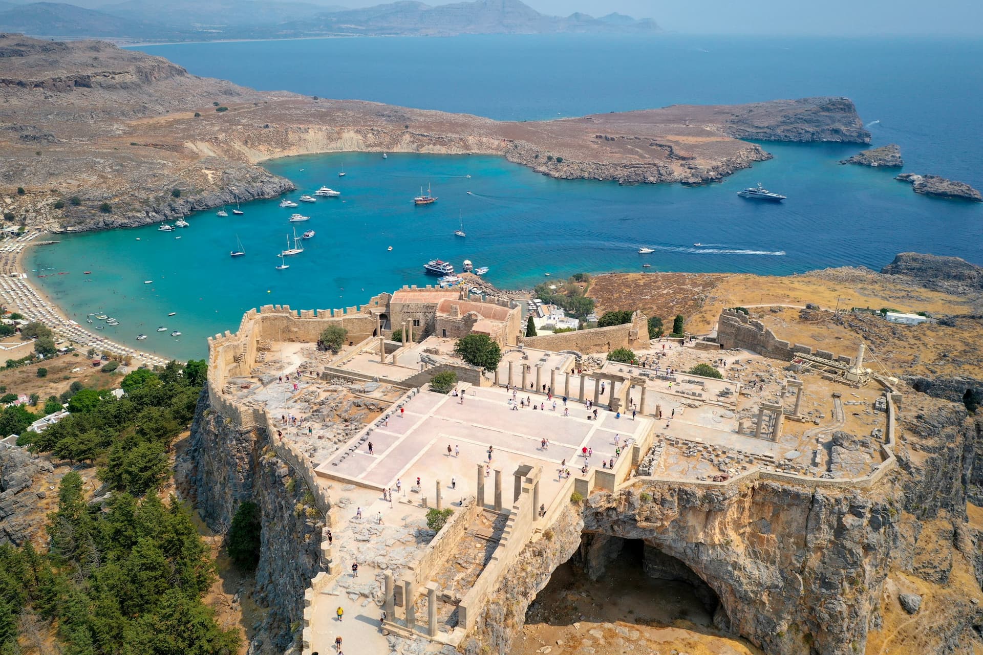 Rhodes car rental destination — aerial view of a medieval castle overlooking the sea, Dodecanese, Greece