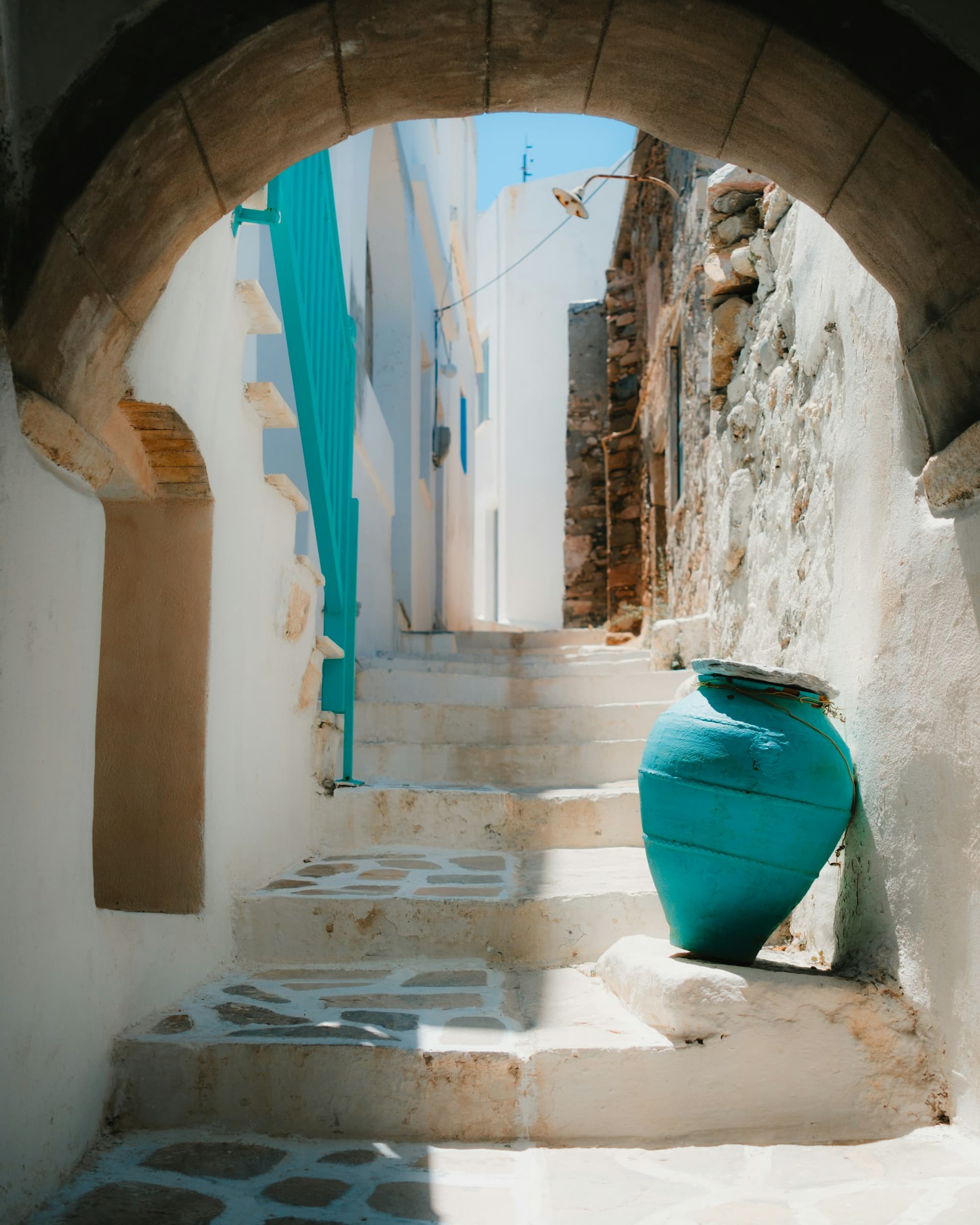Naxos car rental destination — whitewashed steps and a blue vase in the Cyclades, Greece