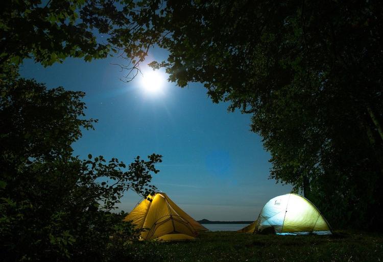 two camping tents under the blue night sky