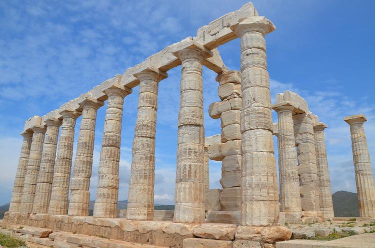 The temple of Poseidon under the blue sky in cape Sounion Attica